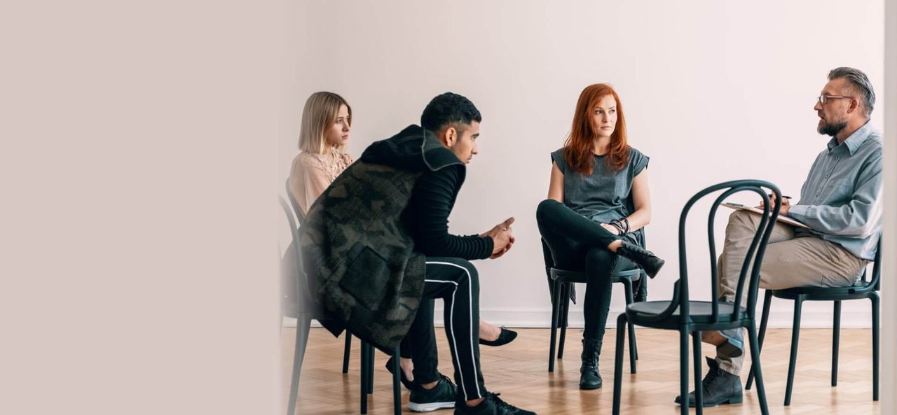 A small group in conversation, seated in a circle